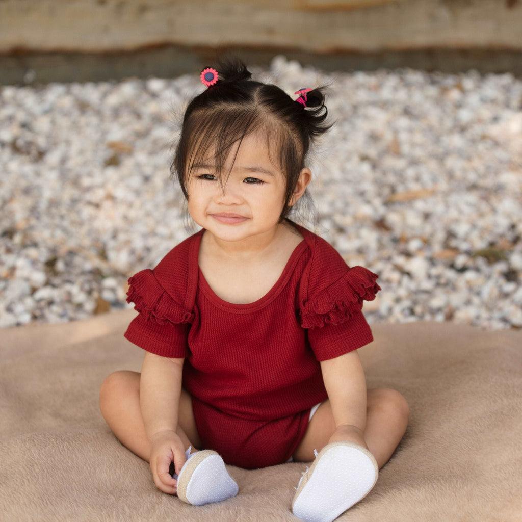 Baby wearing Organic Cotton Wine Ruffled Bodysuit