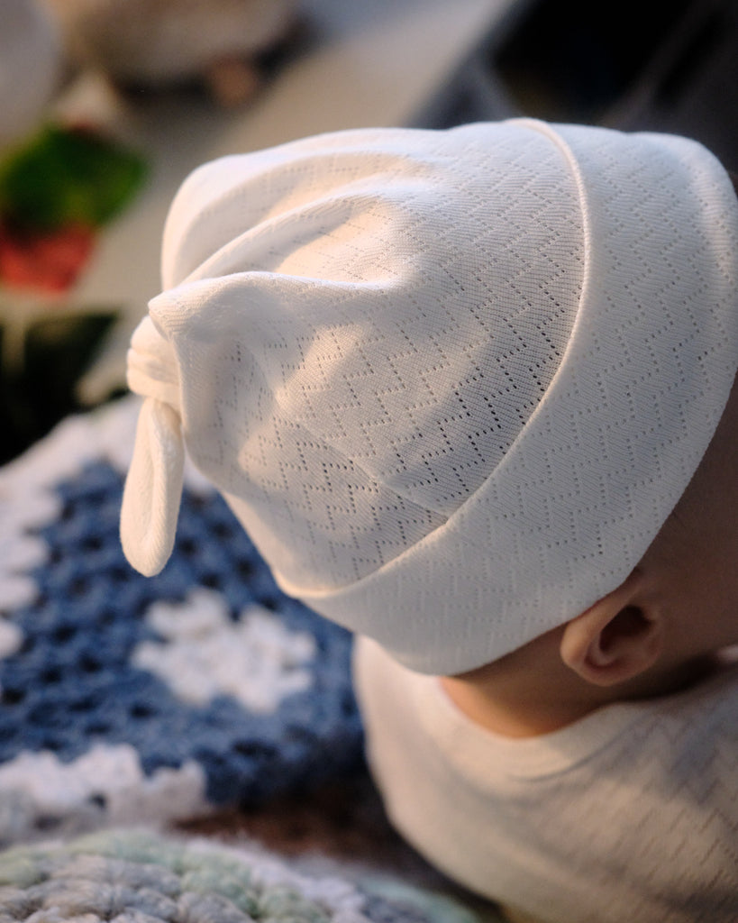 Baby wearing natural organic cotton beanie