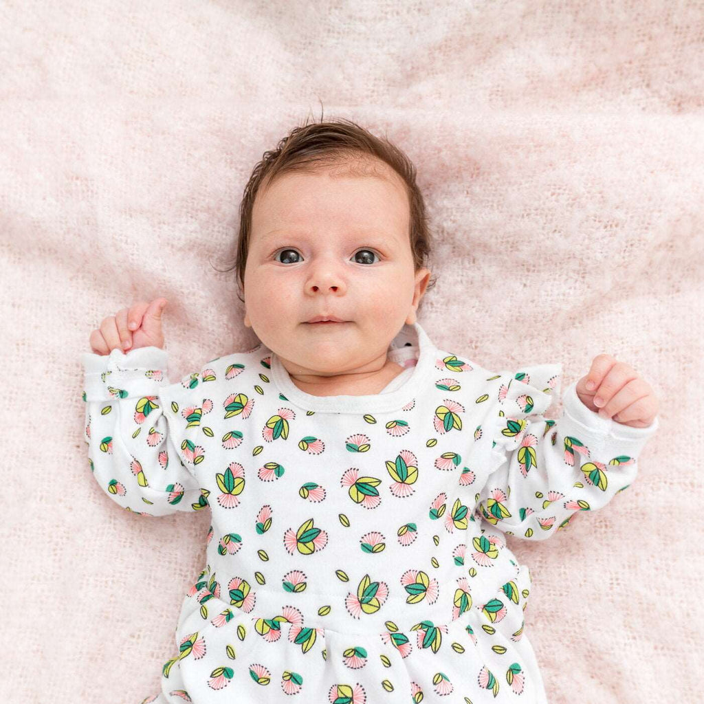 Little girl wearing organic cotton red flowers dress