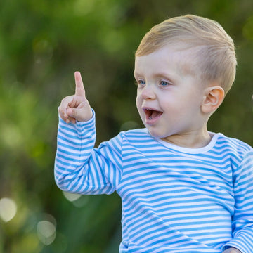 Little boy wearing organic cotton blue striped tshirt